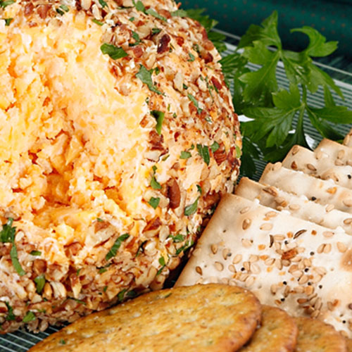 cheese ball with crackers and garnish on the side