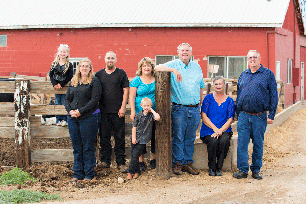 The whole Berhardt family poses in front of their barn.