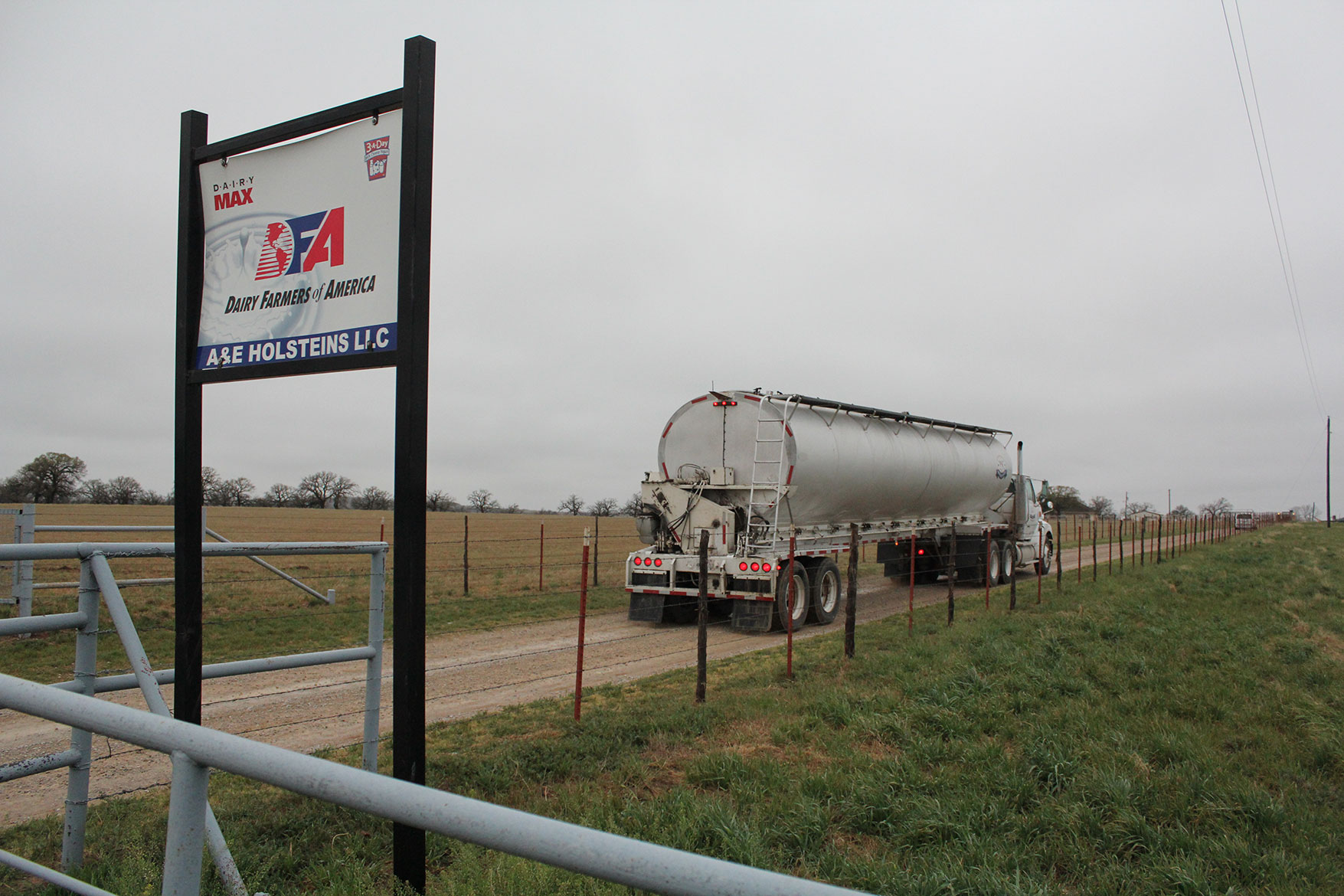 The feed truck delivers feed ingredients to the dairy farm.