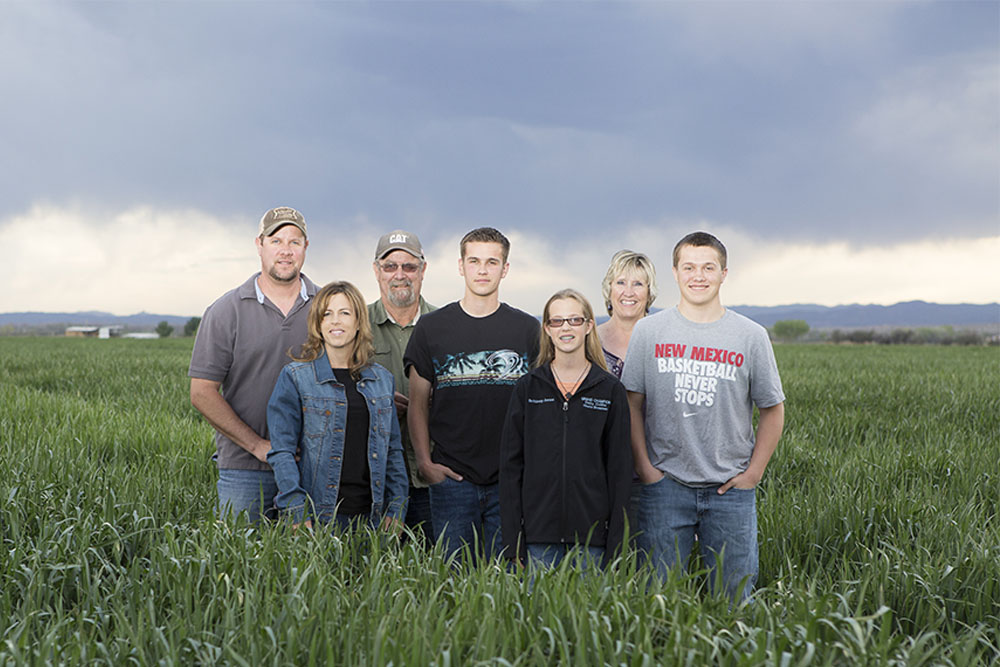 The Jones family takes a photo in one of their fields.