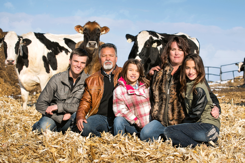 The Dickinson family poses with some of their curious cows.