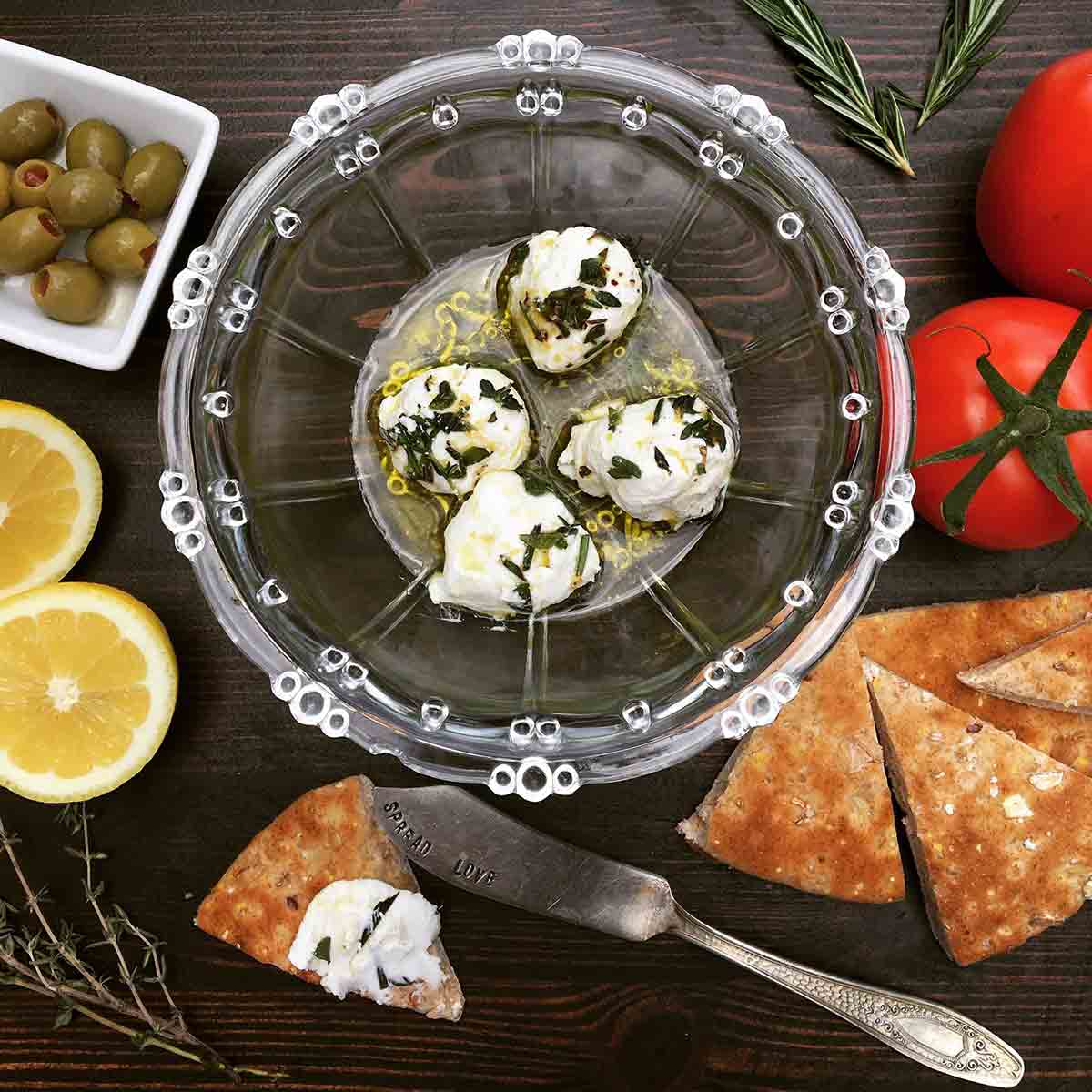labneh in a bowl with tomatoes and pita bread 