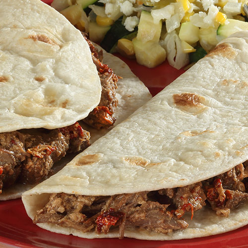 beef tacos on a red plate