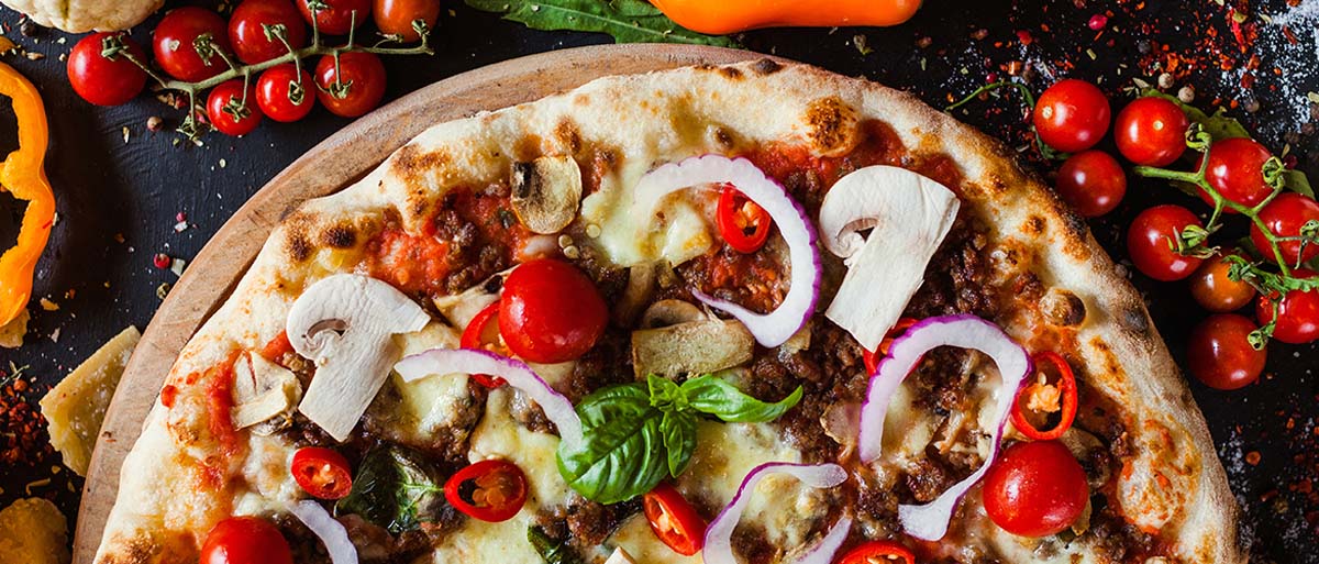 pizza with mushrooms, onions and tomatoes