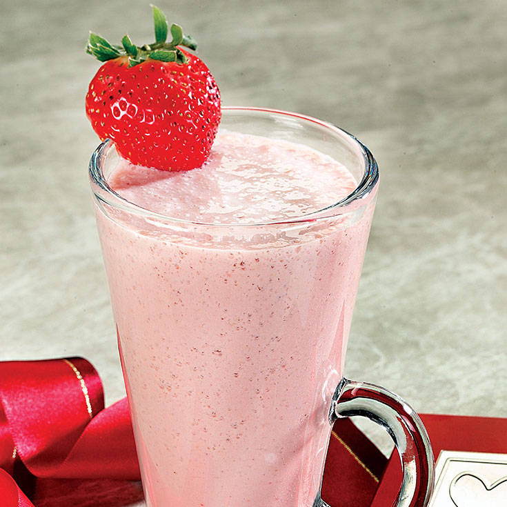 pink smoothie with a strawberry garnish