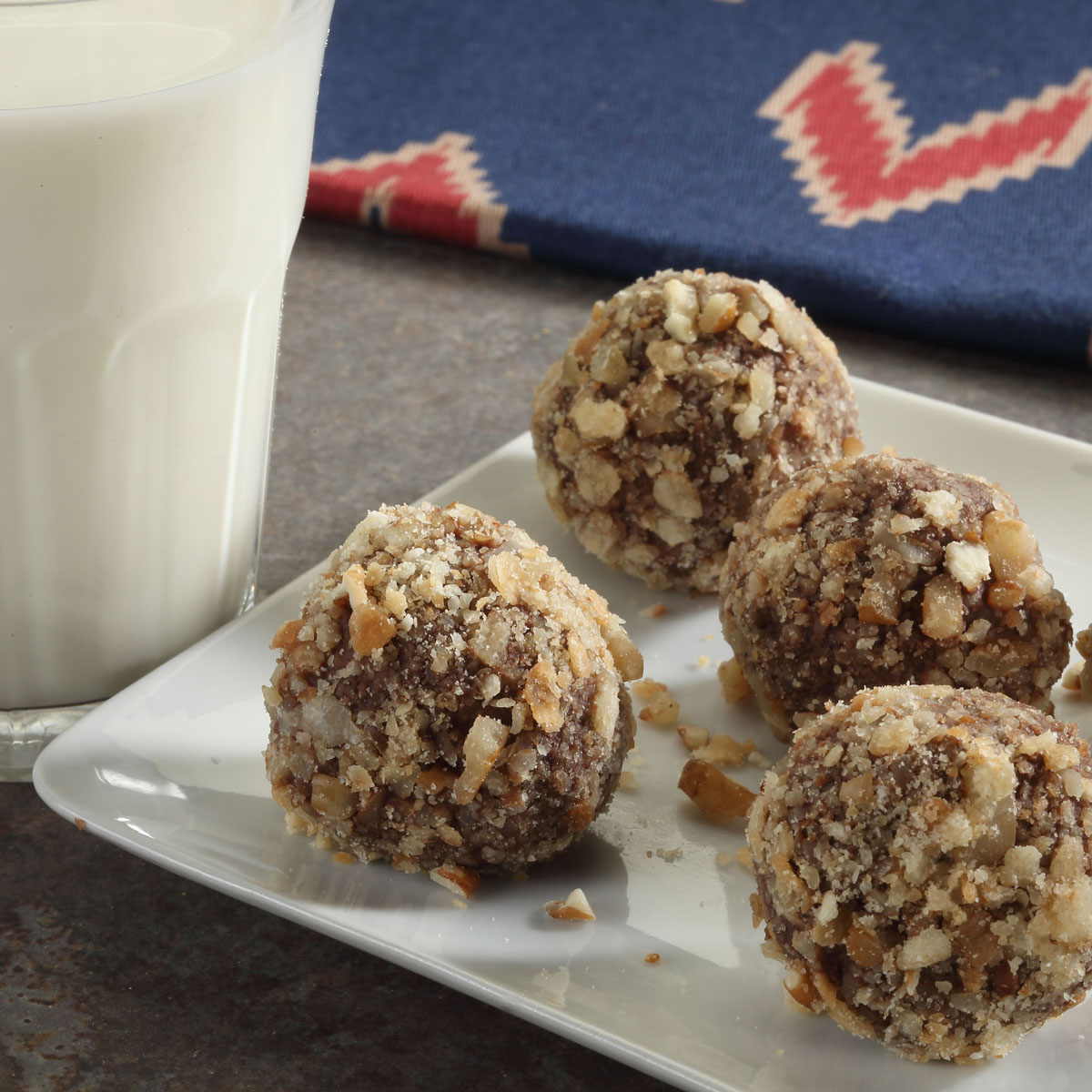 Pecan Pie Truffles with a glass of milk on the side