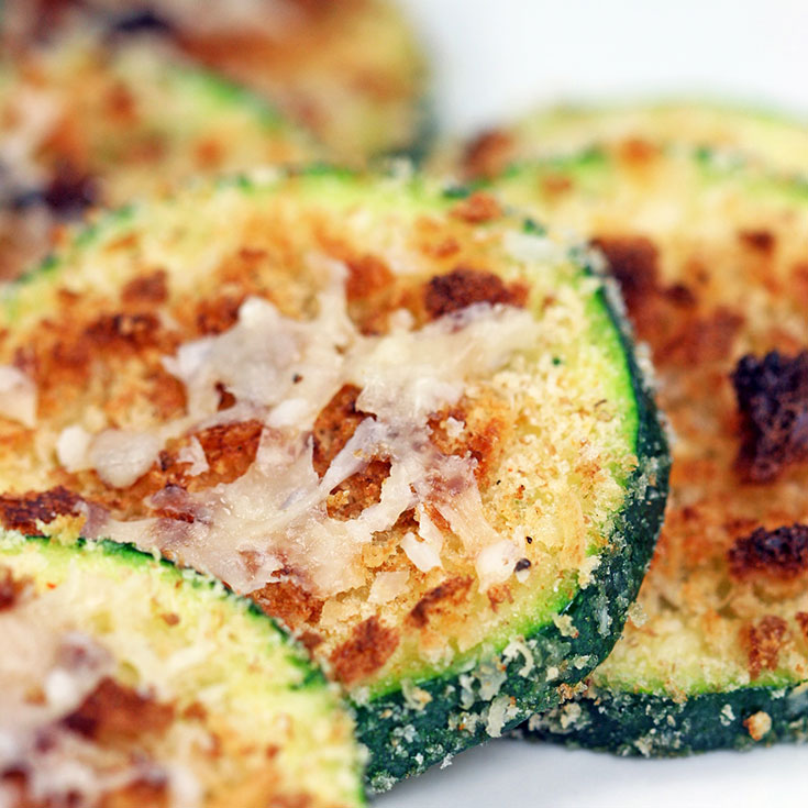 zucchini slices with toasted Parmesan cheese on top