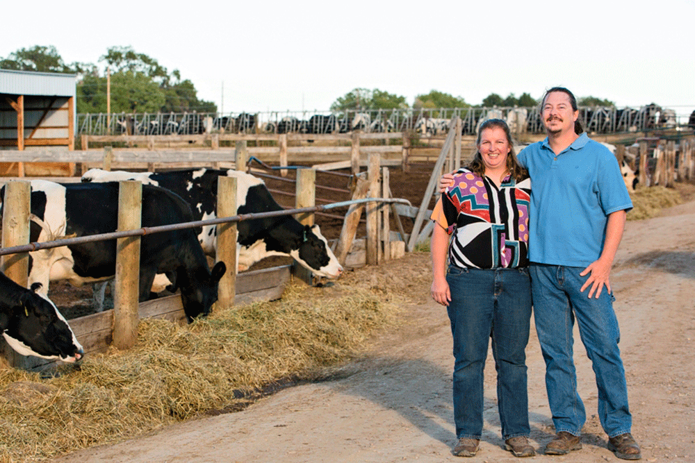 Robin and Bruce Meireis pose for a photograph in front of their dairy.