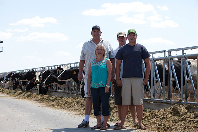 The Alger family in the feed lane where their cows enjoy a meal.