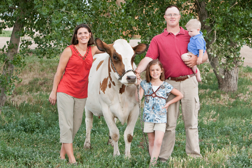 The family poses with their daughter's show cow.