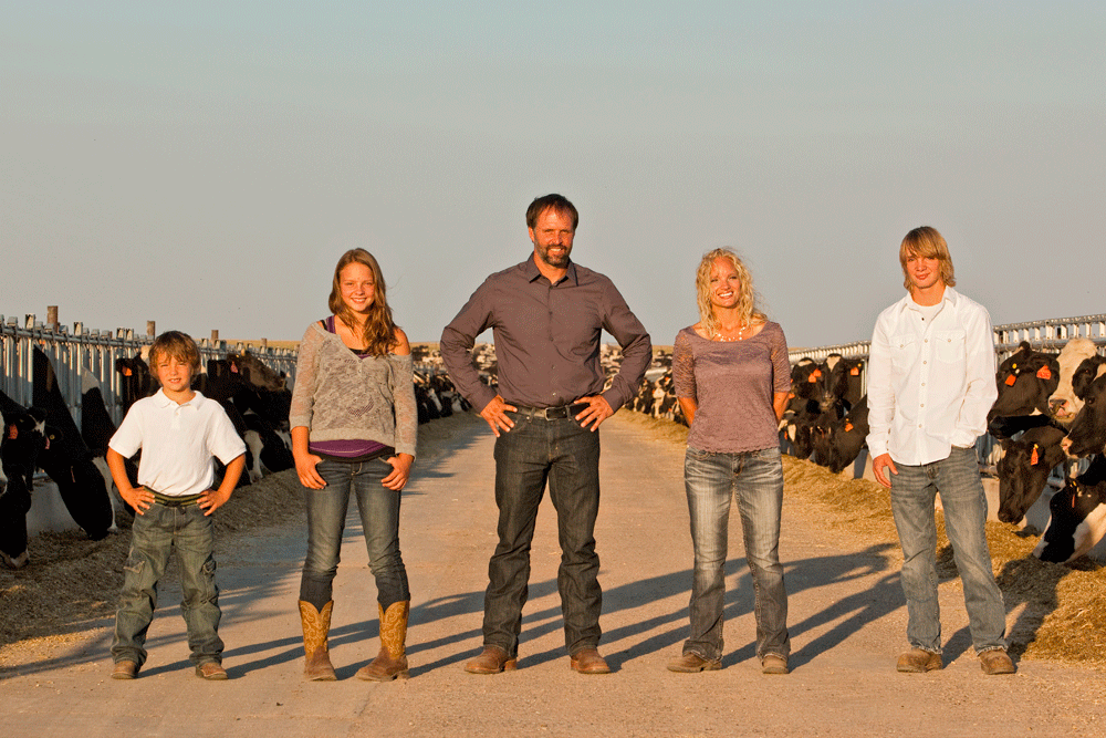 The entire Koolstra family poses in a feed lane on their dairy farm.
