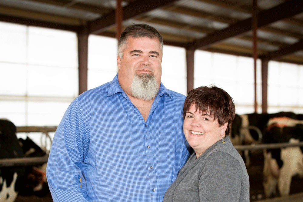 Peter and Tammie Eldred pose for a photo in their barn.