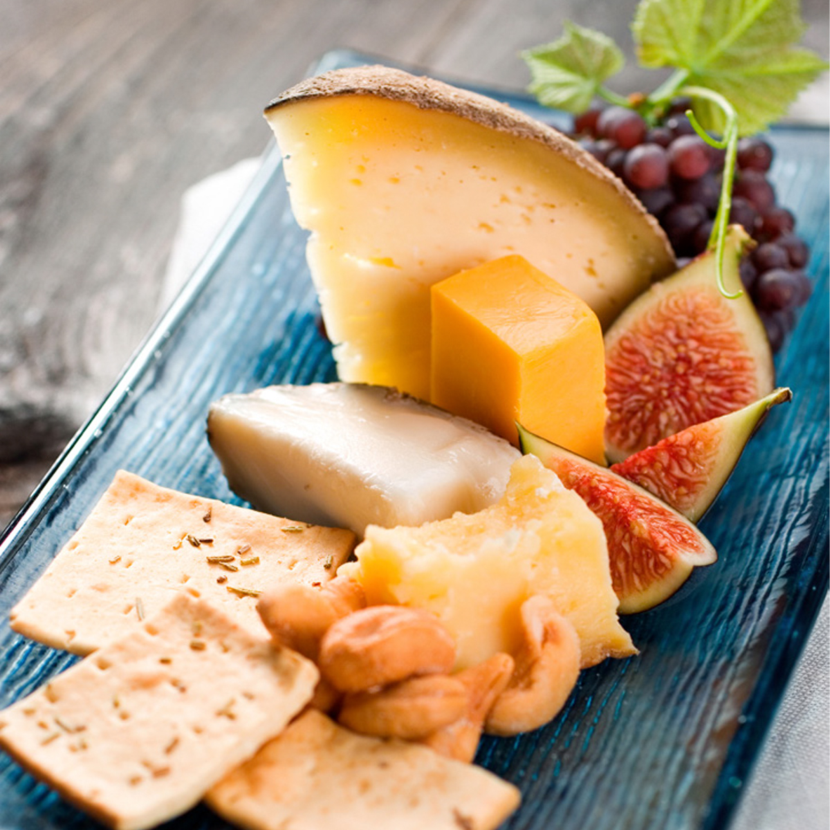 Cheese tray with fruit, nuts, and crackers