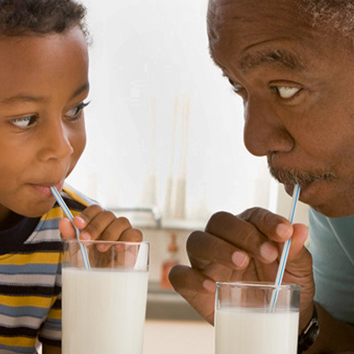 Grandfather and grandson drinking milk
