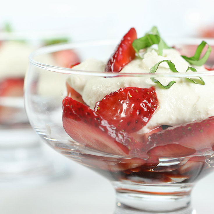 balsamic strawberries in a bowl with ricotta cream topping