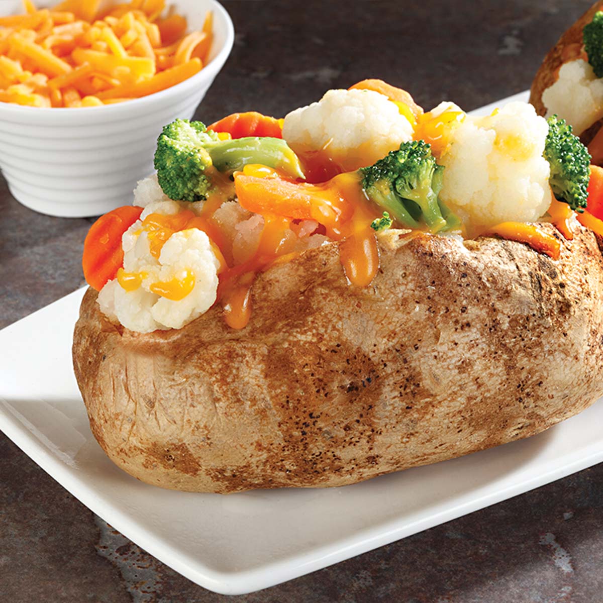 baked potato with cheesy vegetable topping