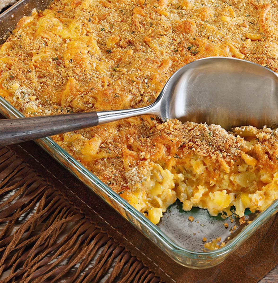 child corn casserole with a serving spoon