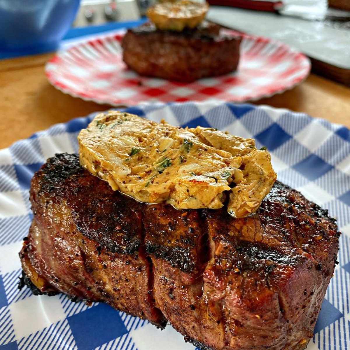 photo of a steak with butter on top