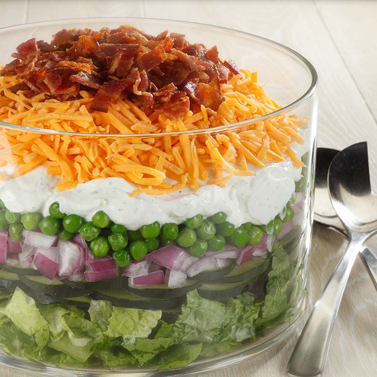 large glass bowl with seven layer salad