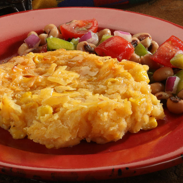 smoked gouda spoon bread on a red plate