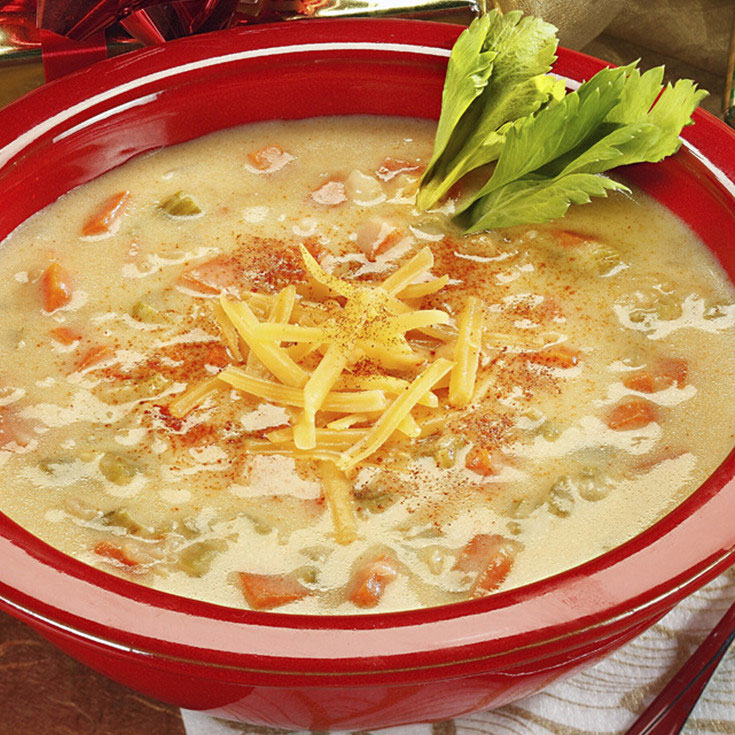 cheese soup in a bowl with cheese garnish