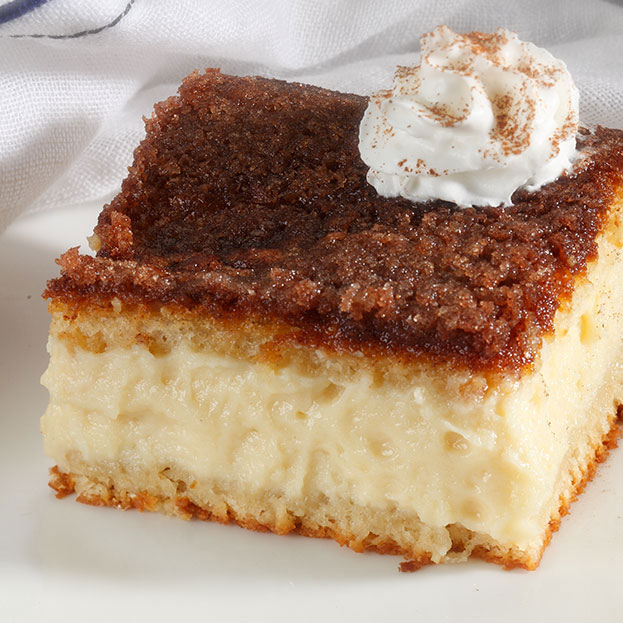 sopapilla cheesecake slice with dollop of whipped cream on top