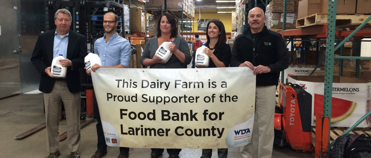 group donating milk to food bank