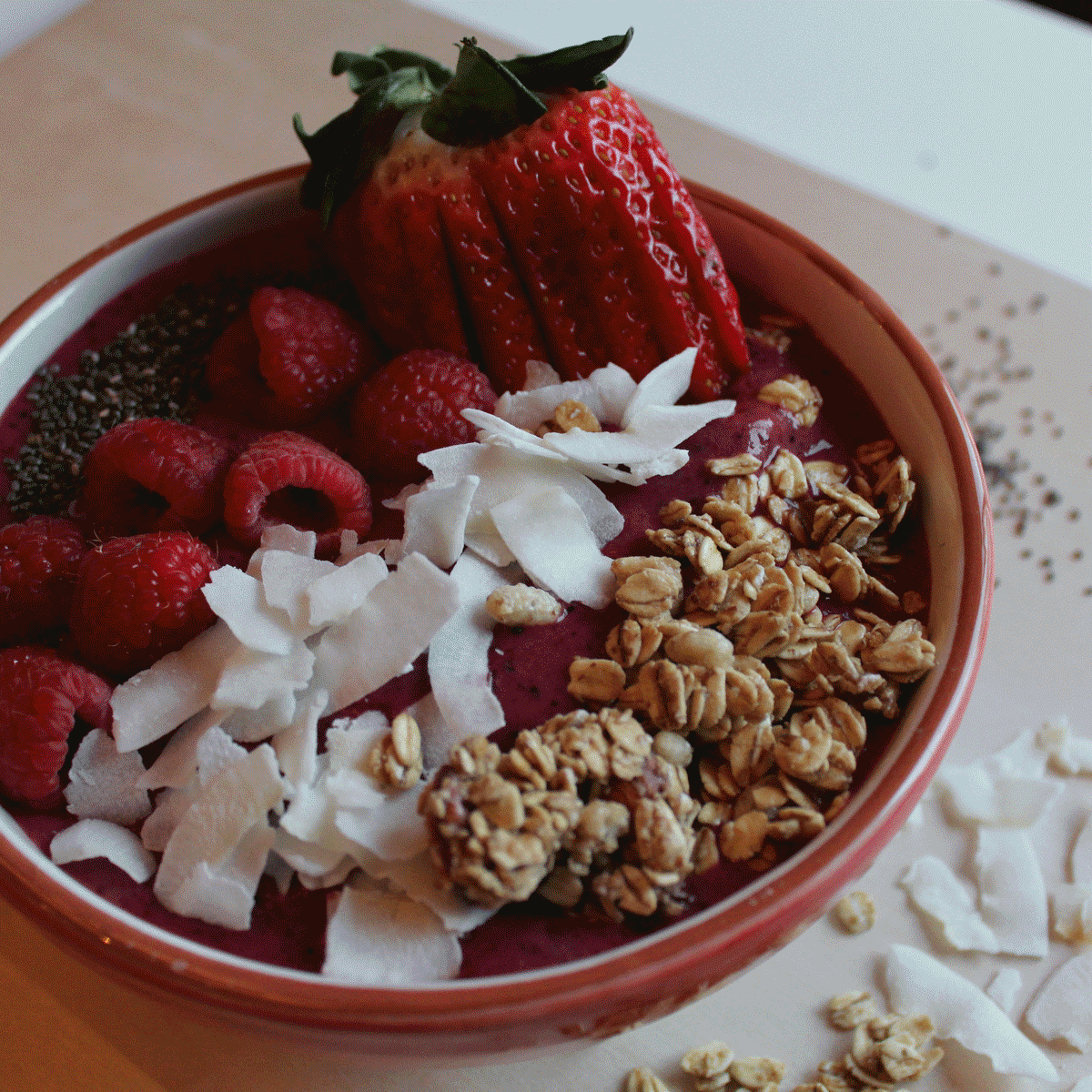 smoothie bowl with strawberries, coconut and granola