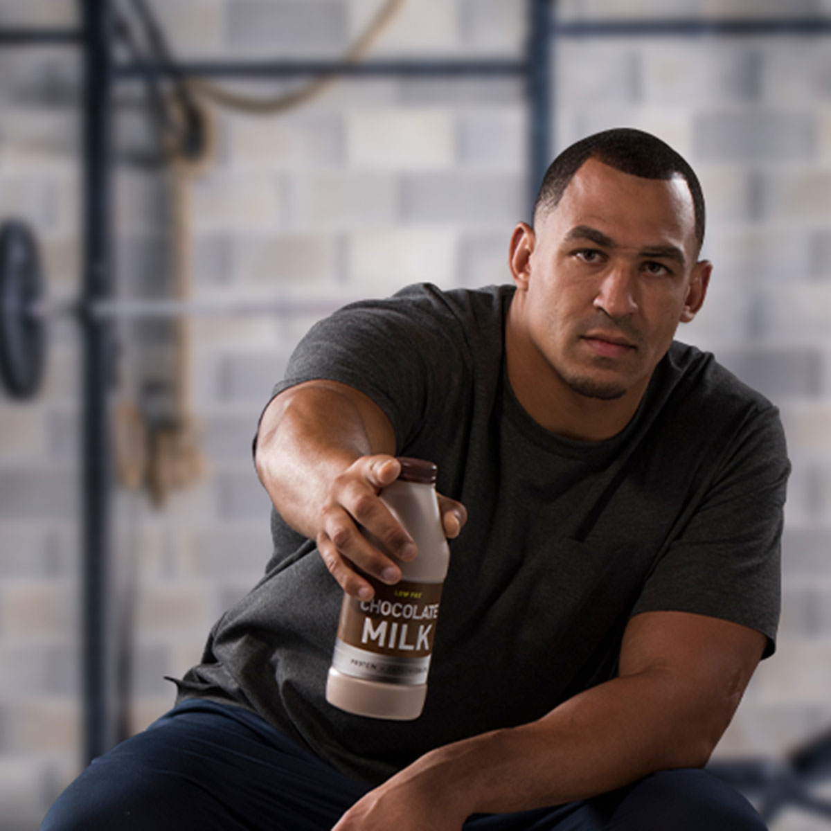 tyrone crawford holding out a bottle of chocolate milk